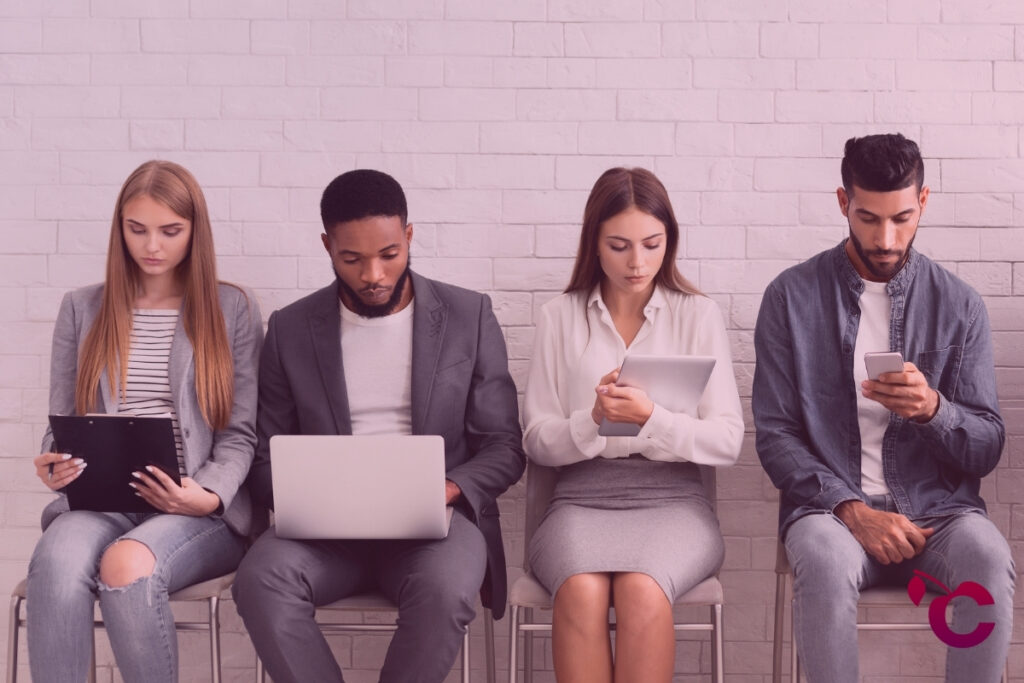 Candidates waiting for job interviews, sitting in row facing recruitment challenge