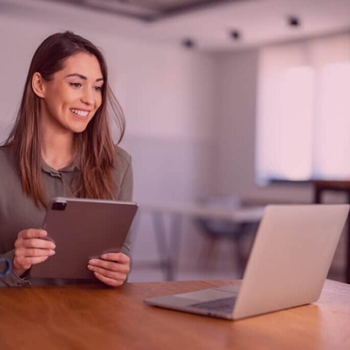 Confident executive in casual clothes using laptop computer to build habits as resilient leaders Confident executive in casual clothes using laptop computer to build habits as resilient leaders