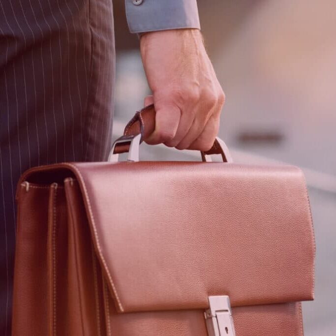 Finance professional holding briefcase applying for work and testing the job market