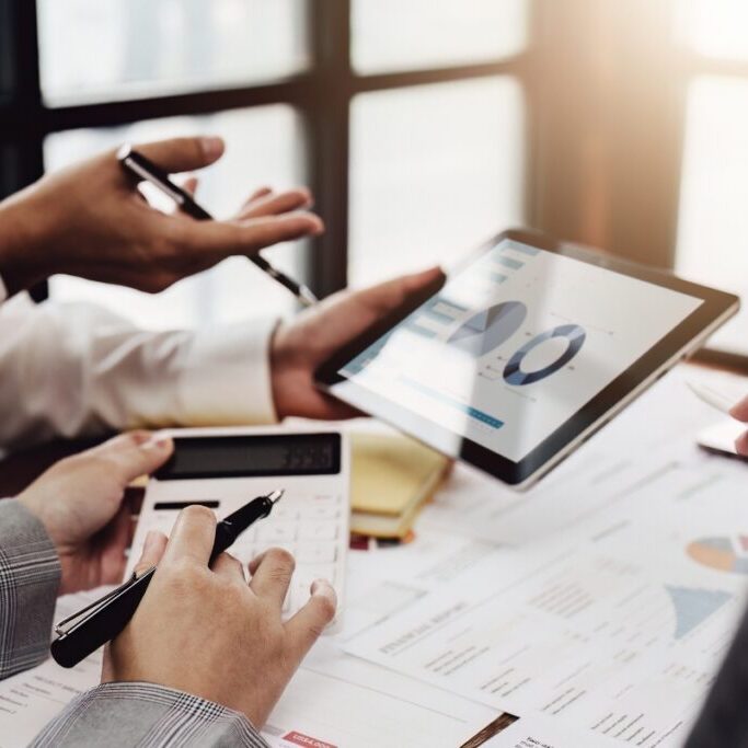 Newly qualified accountants working with partners adjusting finance strategies