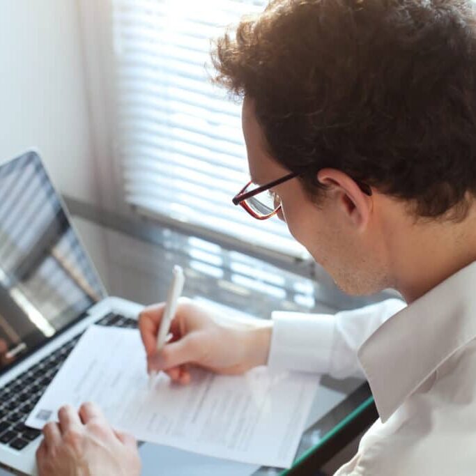 Businessman,Working,With,Documents,In,The,Office